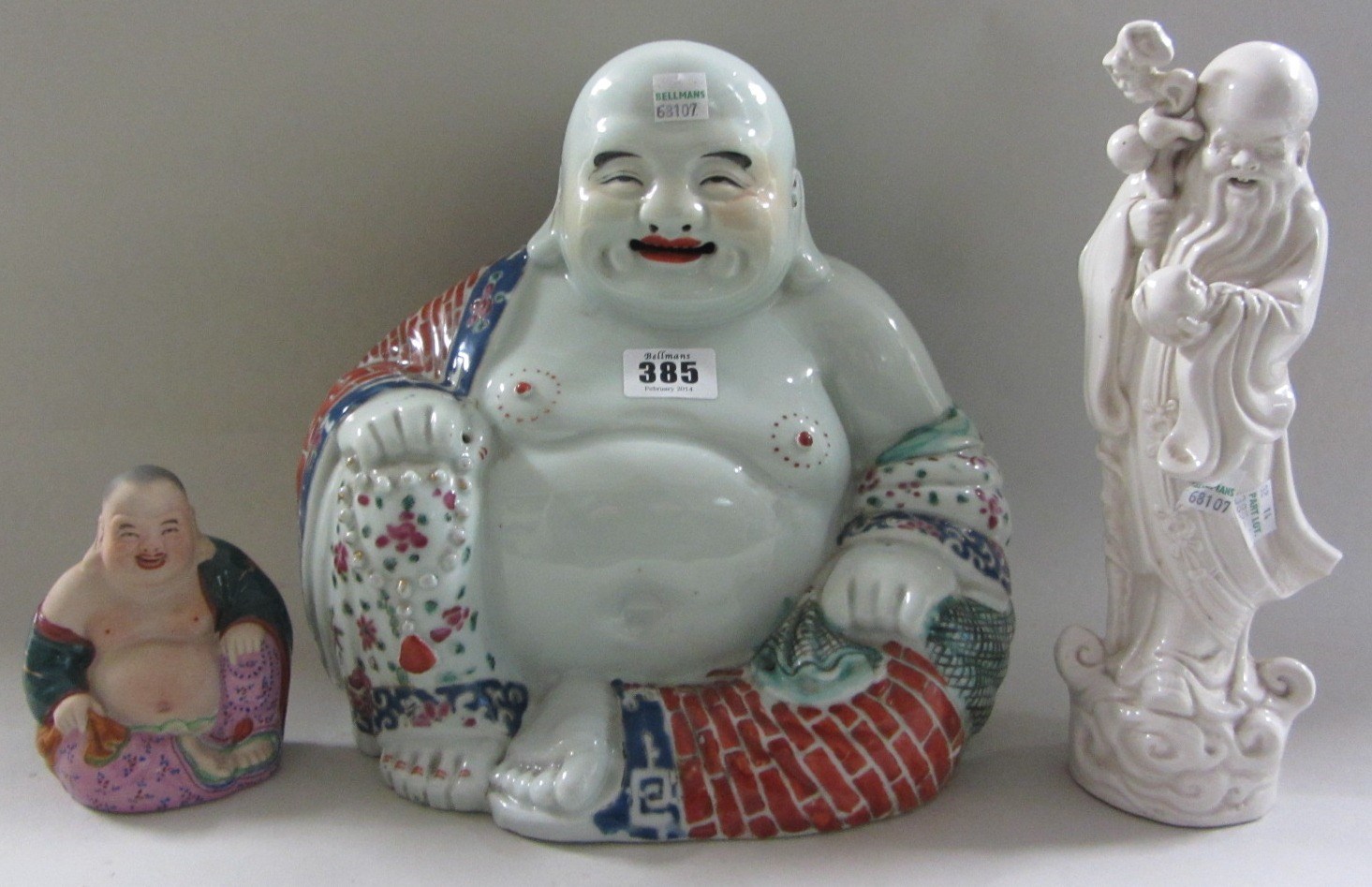 Appraisal: A Chinese porcelain figure of Budai th century seated holding