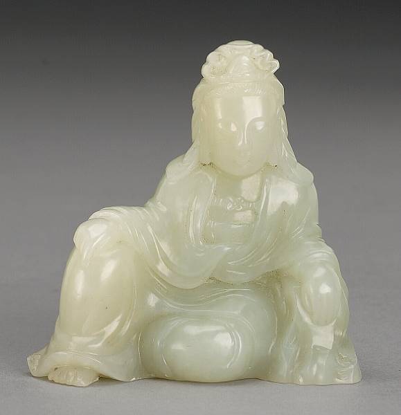 Appraisal: A small carved white jade figure of Guanyin th Century