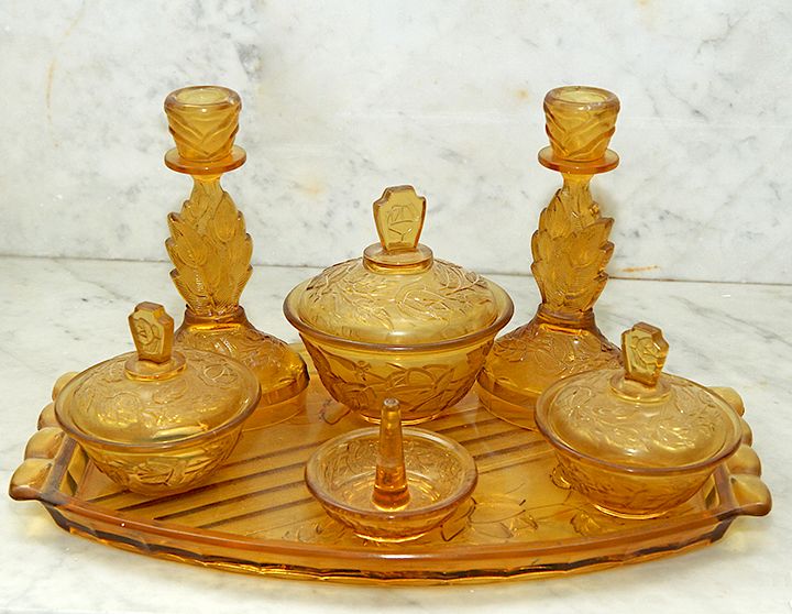 Appraisal: Amber Dresser Set A seven piece Depression era dresser set