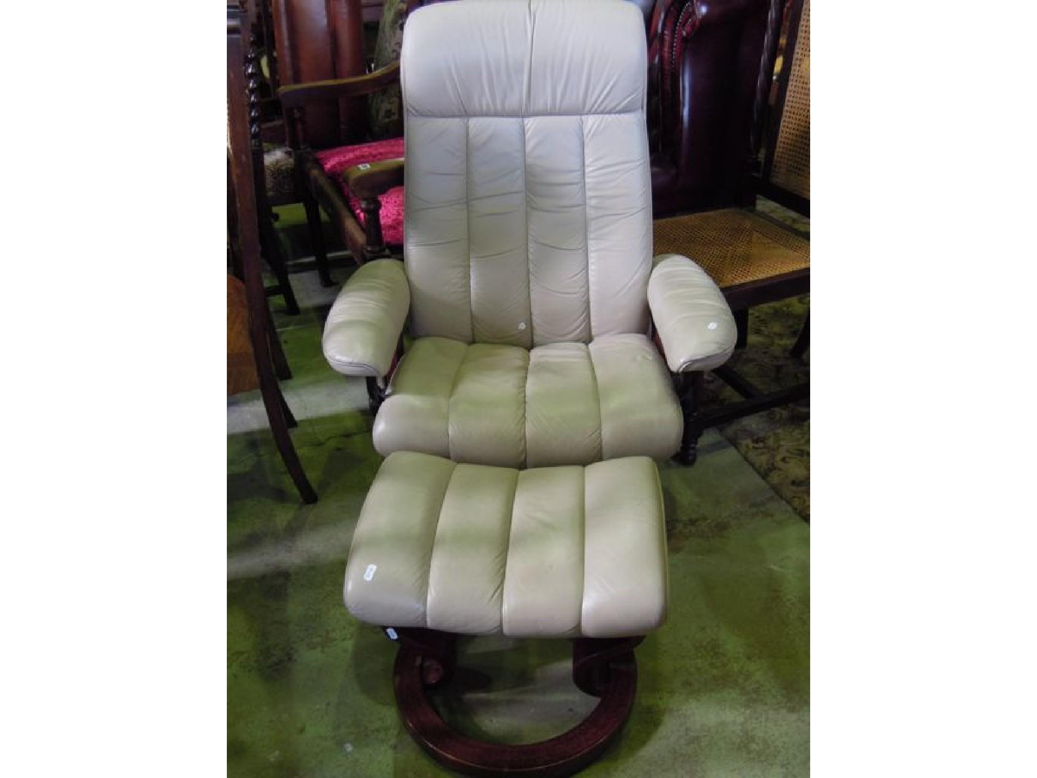 Appraisal: An Ekornes Stressless cream leather upholstered armchair and matching footstool