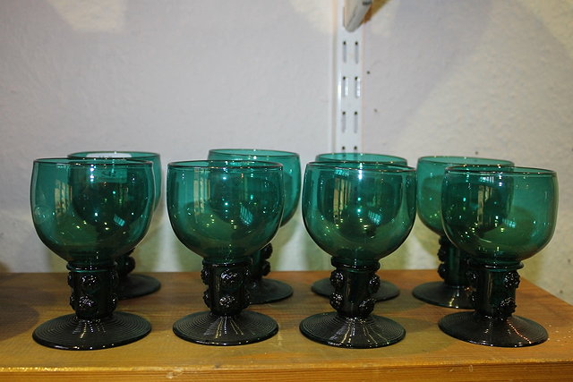 Appraisal: A SET OF EIGHT GREEN GLASS WINE GOBLETS cm high