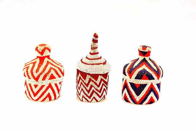 Appraisal: A COLLECTION OF THREE TUTSI RWANDA BEAD WORK LIDDED BASKETS