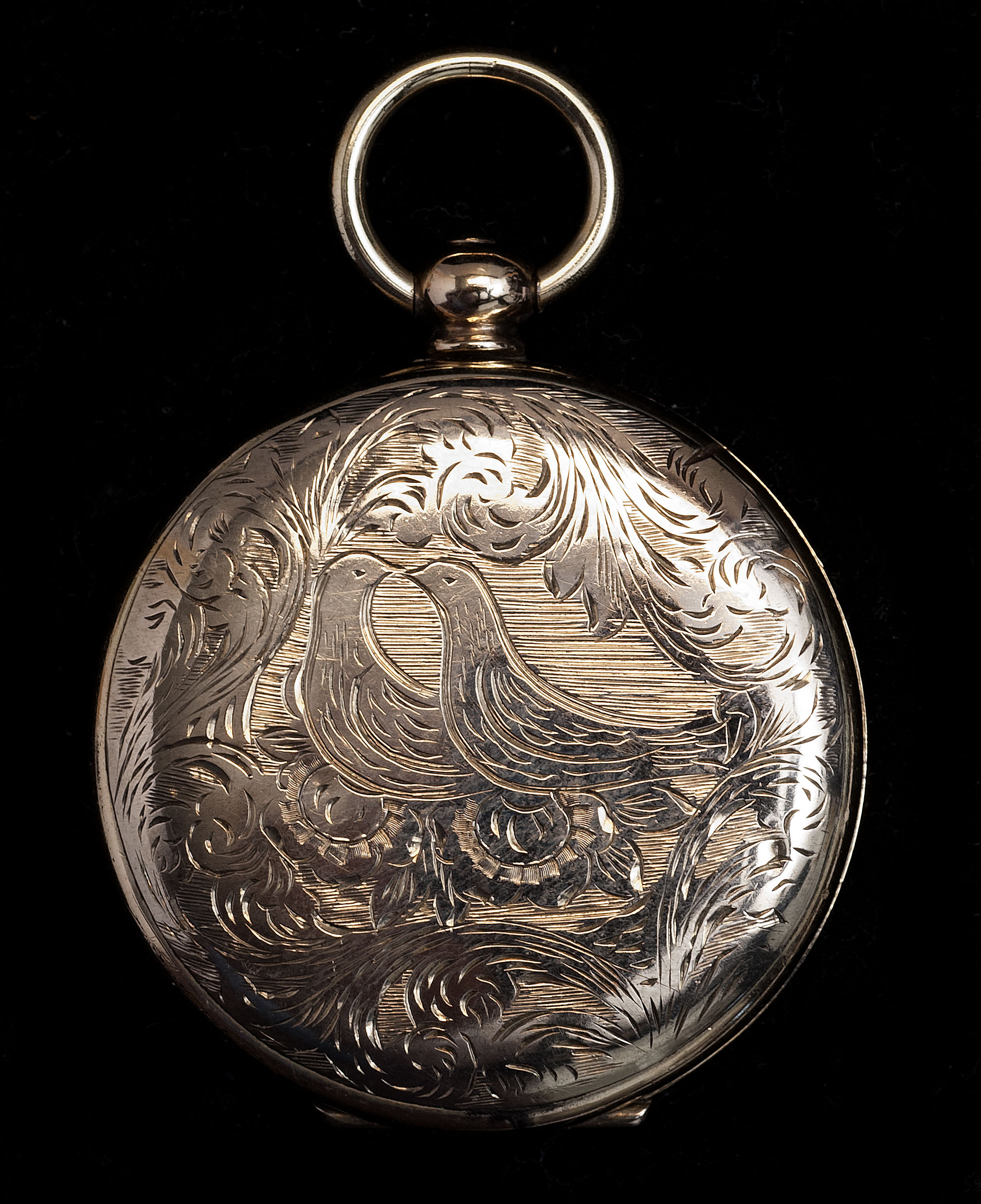 Appraisal: GOLD-CASED LOCKET Engraved with lovebird design With daguerreotypes of a