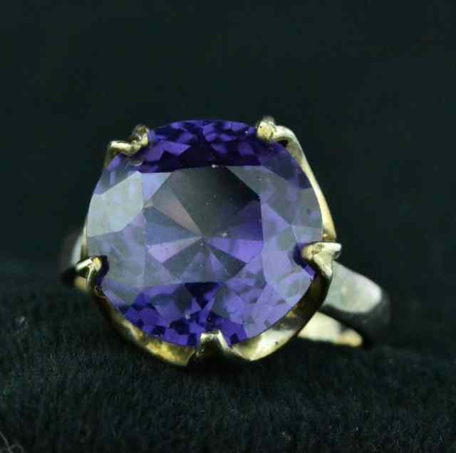 Appraisal: LADY'S PURPLE SILVER RINGConsisting of synthetic purple sapphire stone in