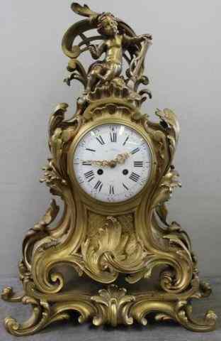 Appraisal: French Gilt Bronze Rococo Style Clock With putti surmount attached