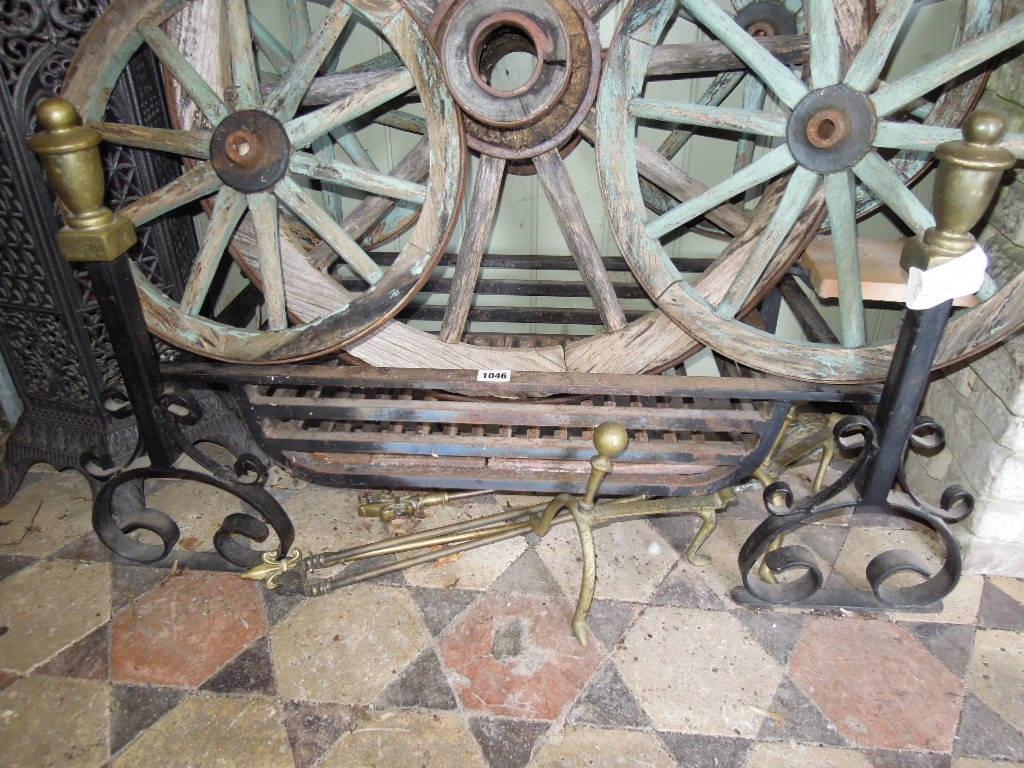 Appraisal: A cast iron fire grate and dogs with simple scroll