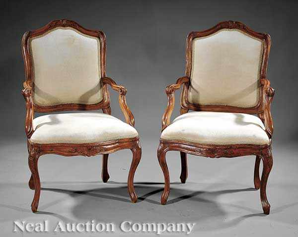 Appraisal: A Pair of Louis XV Fruitwood Fauteuils th c found