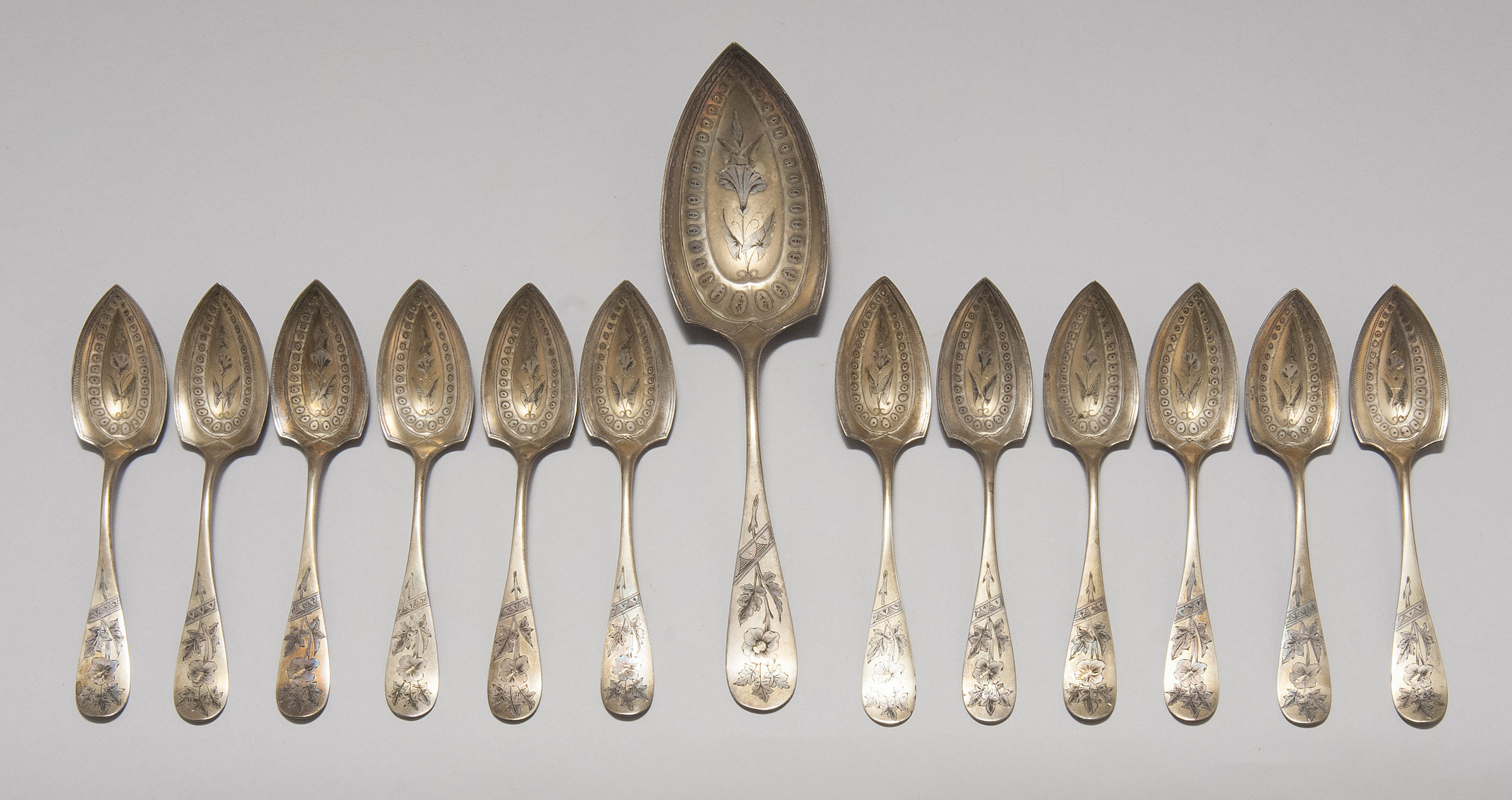 Appraisal: THIRTEEN AMERICAN AESTHETIC STERLING SILVER FRUIT SPOONS Third Quarter of