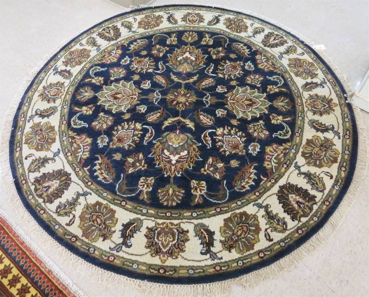 Appraisal: A ROUND ORIENTAL AREA RUG Indo-Persian floral design on dark