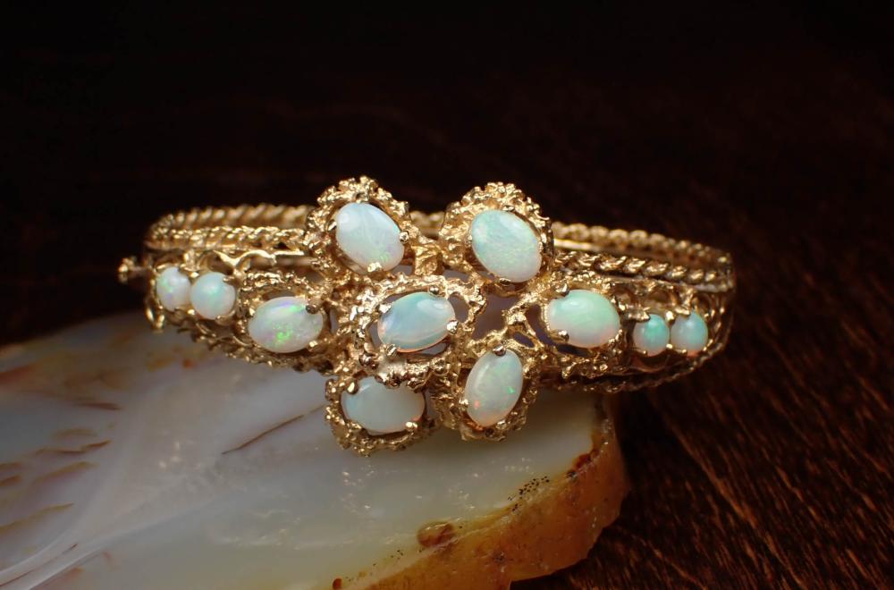 Appraisal: OPAL AND FOURTEEN KARAT GOLD BANGLE BRACELET The oval hinged