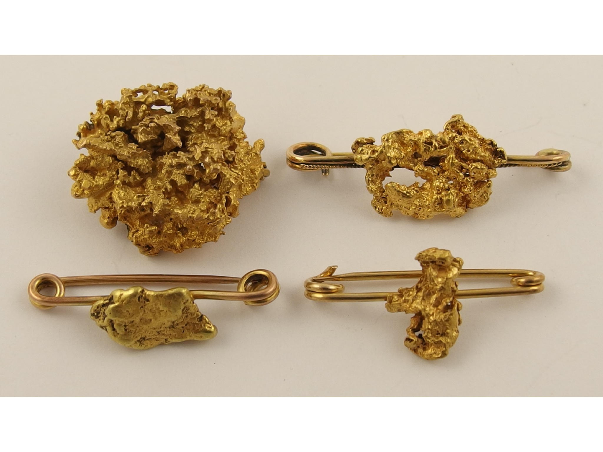 Appraisal: A collection of four yellow metal nugget broochesall weights and