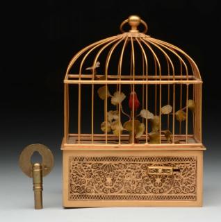 Appraisal: Bird in a Snuff Box in a Domed Cage An