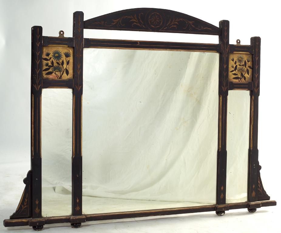 Appraisal: AESTHETIC EBONISED GILT-HIGHLIGHTED TRIPARTITE OVERMANTEL MIRROR the arched crest carved