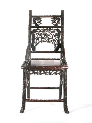 Appraisal: A Chinese hardwood chair intricately carved with blossoming prunus th