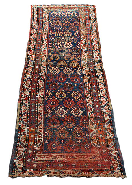 Appraisal: AN ANTIQUE ORIENTAL BLUE GROUND RUNNER with floral motifs to