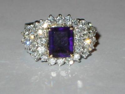 Appraisal: AN AMETHYST AND DIAMOND COCKTAIL RING comprising an emerald cut