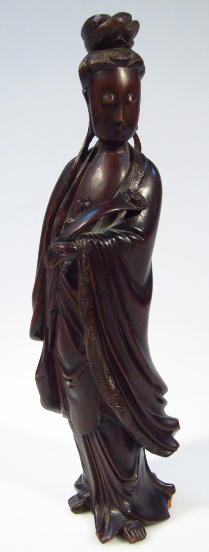 Appraisal: A thC Chinese hardwood figure of a lady wearing flowing