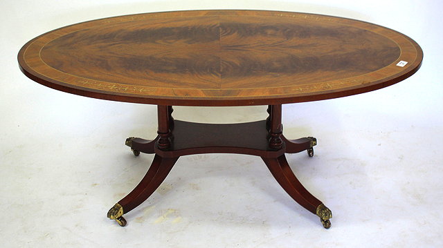 Appraisal: A LOW OVAL OCCASIONAL TABLE with decorative brass inlay standing