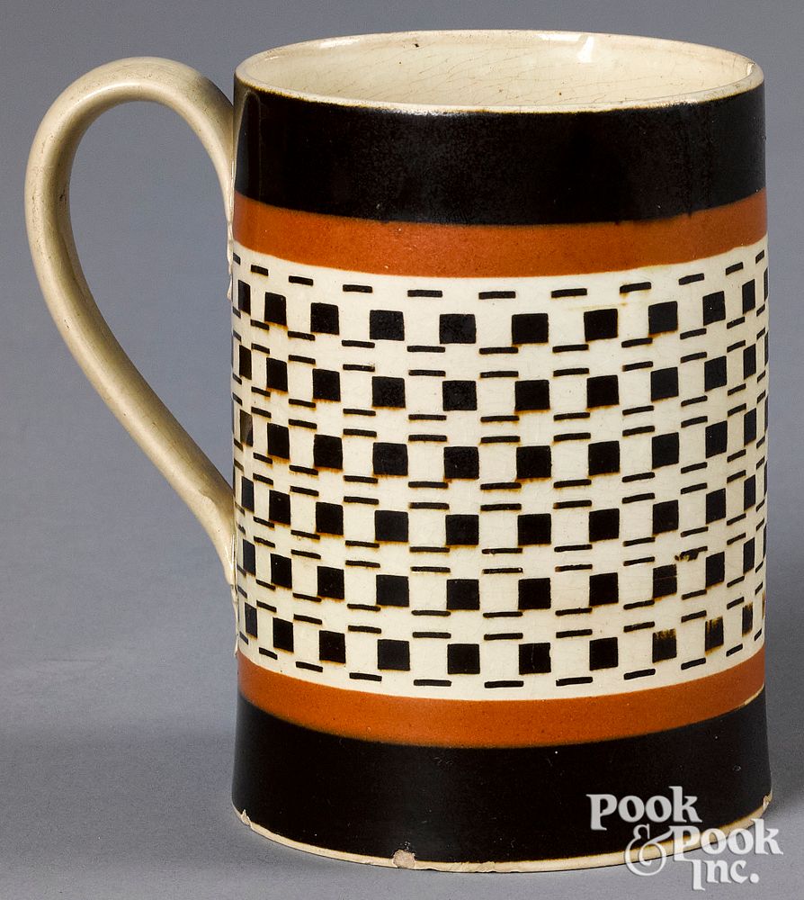 Appraisal: Mocha mug with brown engine turned decoration Mocha mug with