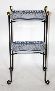 Appraisal: Maitland Smith iron -tier table with blue white porcelain trays