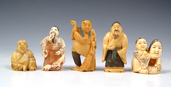 Appraisal: FIGURAL JAPANESE CARVED IVORY NETSUKE To include Man with fish