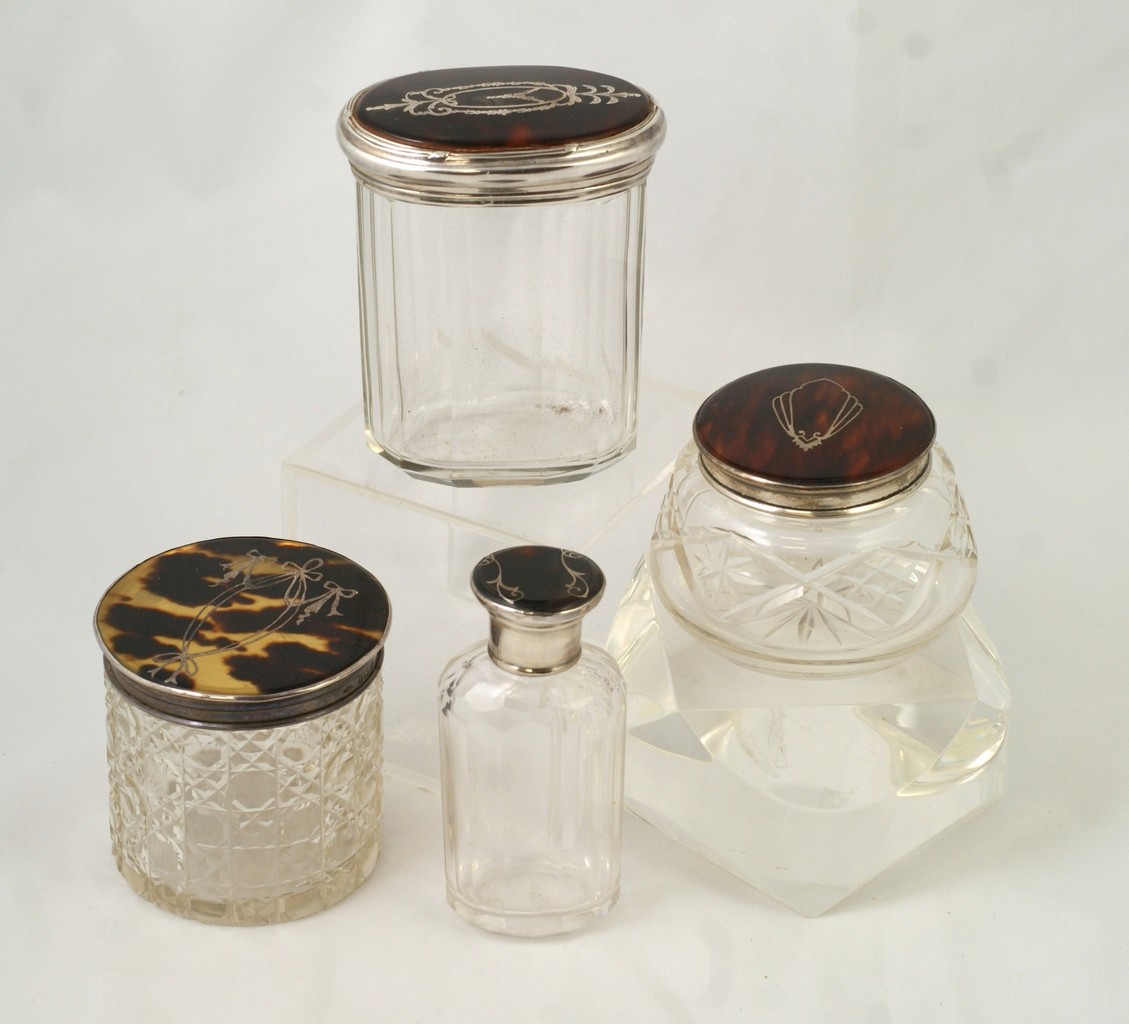 Appraisal: sterling and tortoise shell topped dresser jars all with English