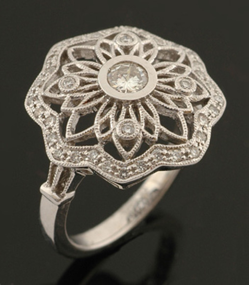 Appraisal: A diamond cluster ring The pierced floral design centrally set