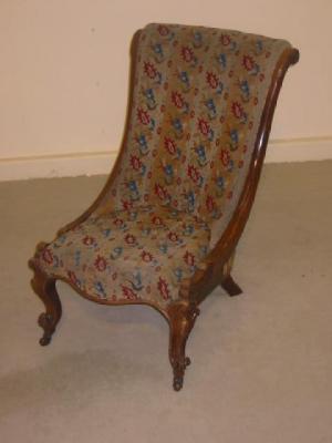 Appraisal: A VICTORIAN WALNUT NURSING CHAIR upholstered in original striped woolwork