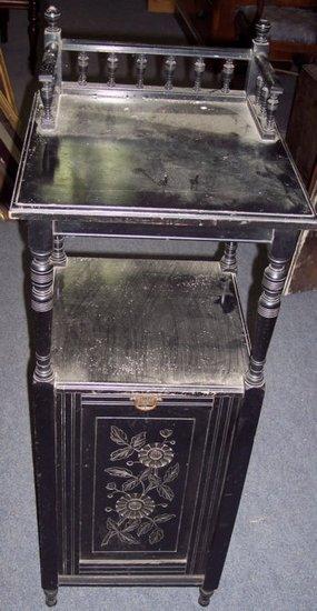 Appraisal: An Edwardian ebonised purdonium with galleried back and carved fall