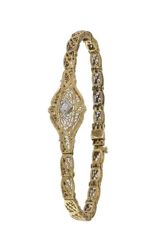 Appraisal: K FILIGREE DIAMOND BRACELET K yellow gold filigree bracelet contains