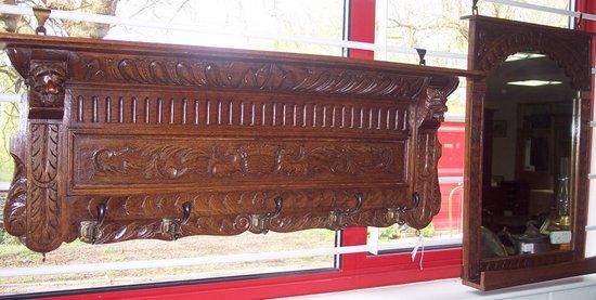 Appraisal: A carved oak coat rack with lion mask detail and