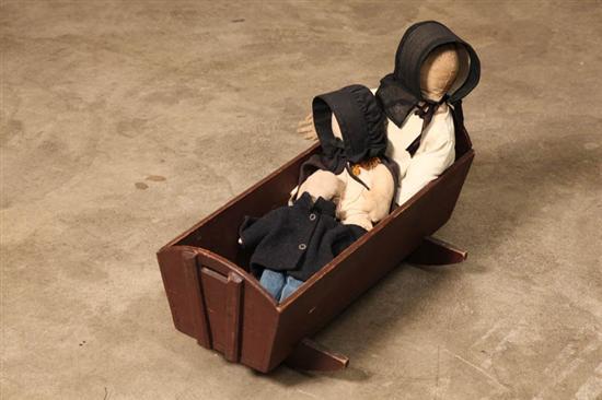 Appraisal: THREE AMISH DOLLS AND A CRADLE A woman with fingers