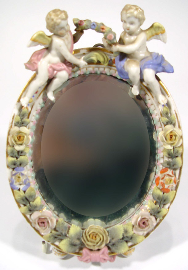 Appraisal: Continental oval porcelain framed mirror with cherub and floral mouldings