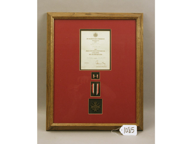 Appraisal: Framed and matted German WWII Knight's Cross brass with crossed