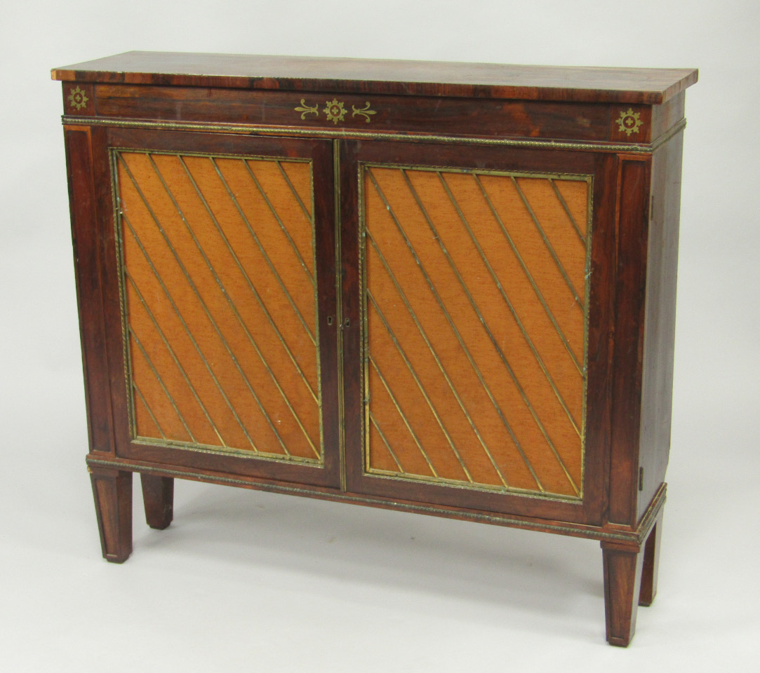 Appraisal: A Regency rosewood chiffonier with two fabric backed doors opening