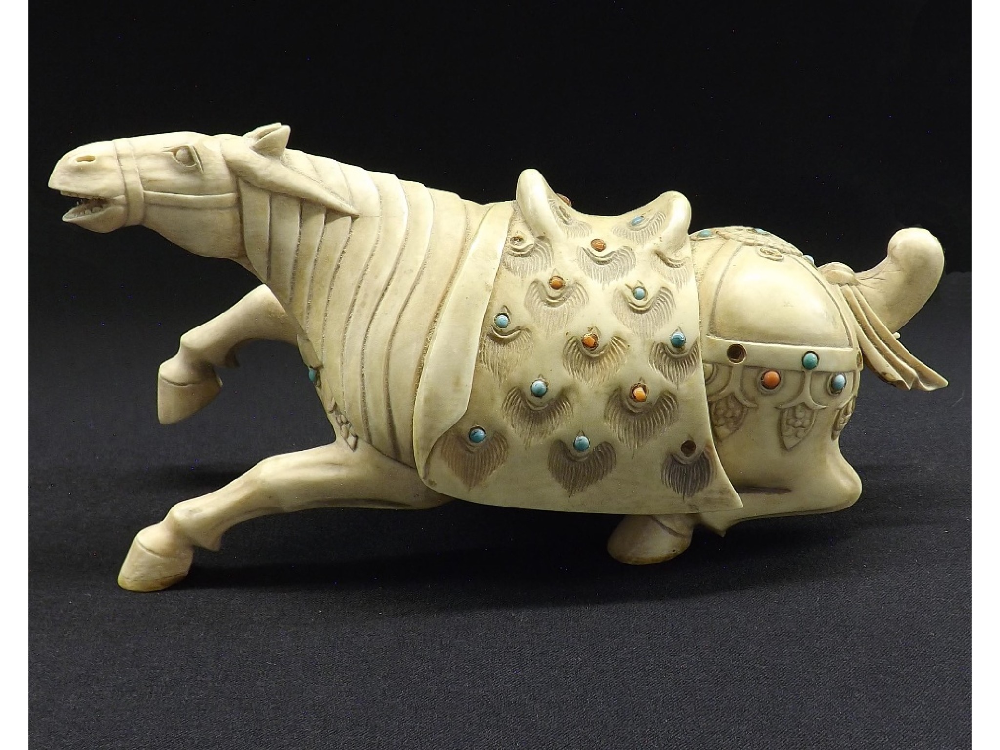 Appraisal: Carved ivory horse with jewelled saddle long overall