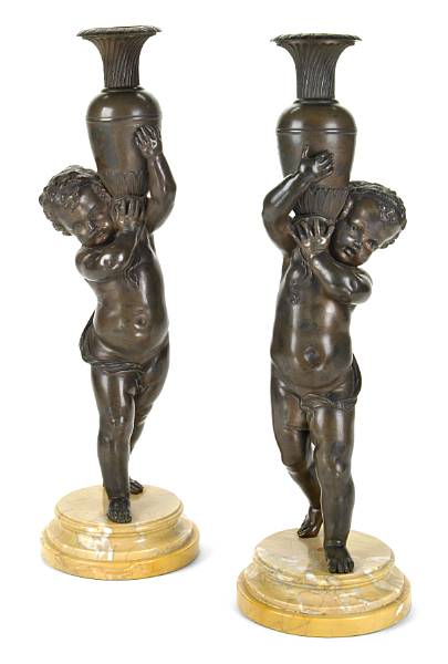 Appraisal: A pair of French patinated bronze figures of putti late