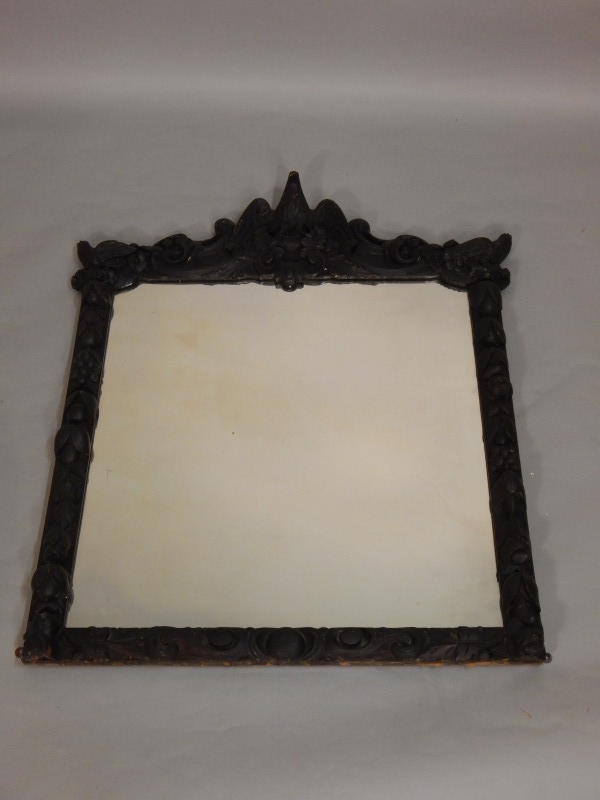 Appraisal: A Victorian ebonised wall mirror with central eagle crest the