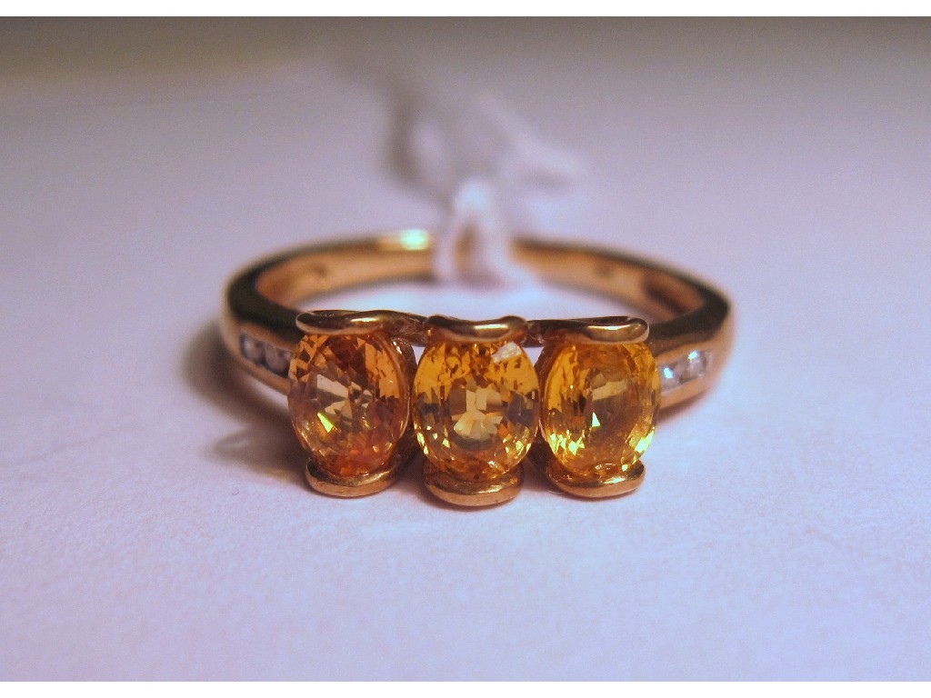 Appraisal: Nine carat gold citrine three stone ring with diamond set