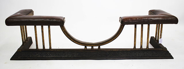 Appraisal: AN EDWARDIAN LEATHER UPHOLSTERED BRASS AND CAST IRON CLUB FENDER