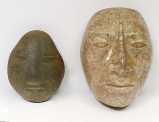 Appraisal: TWO CARVED STONE MASKS One polished height the other natural