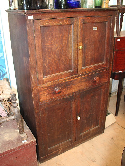 Appraisal: A VICTORIAN OAK CUPBOARD with twin panelled doors above over