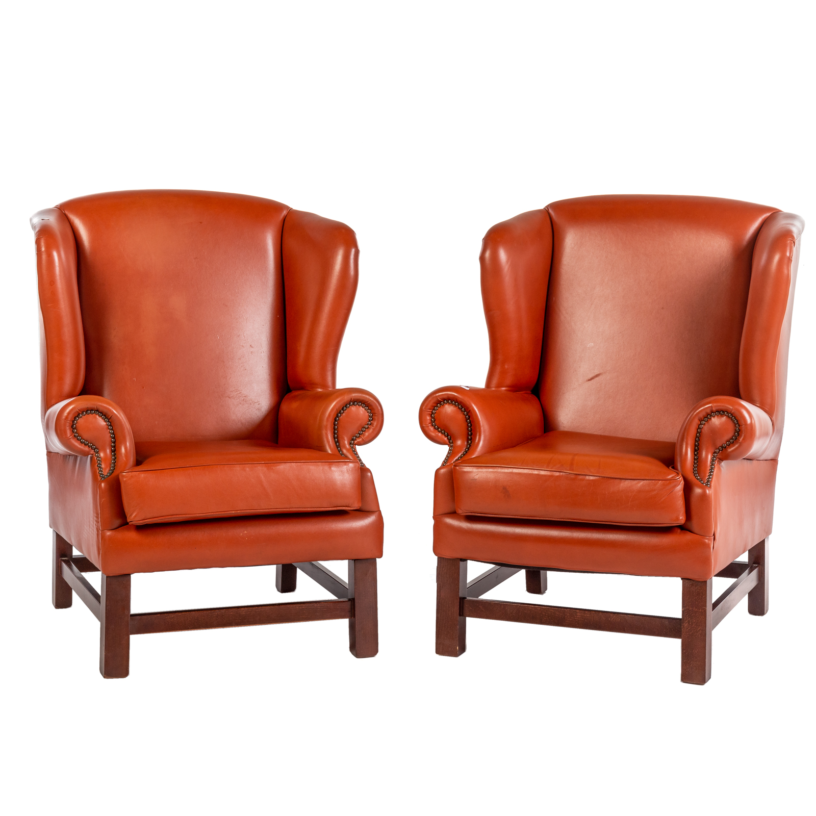 Appraisal: A PAIR OF LEATHER WING CHAIRS th century stained mahogany