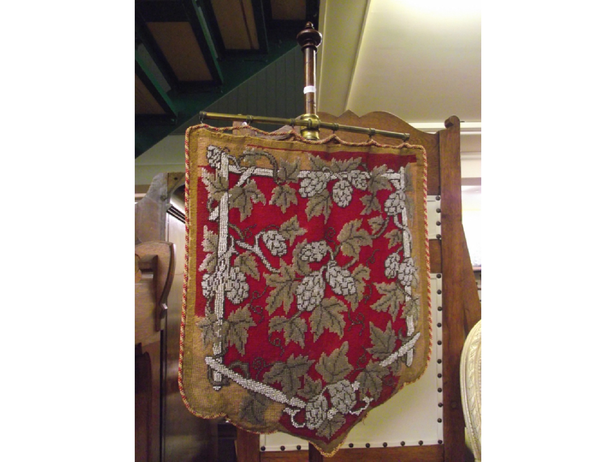 Appraisal: An early Victorian walnut framed pole screen with carved tripod