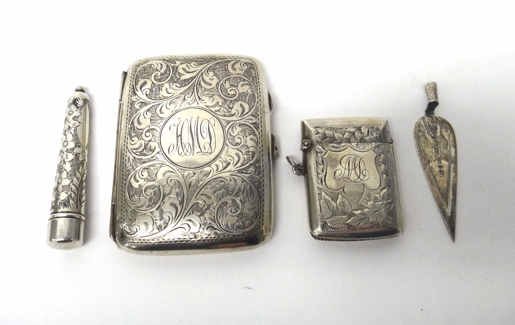 Appraisal: Silver comprising a rectangular cigarette case with feathered scroll engraved