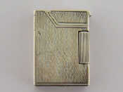 Appraisal: A silver Dunhill cigarette lighter the case engine turned diamond