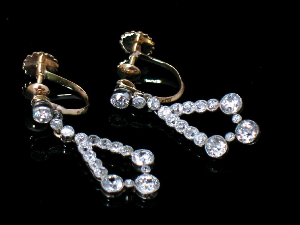 Appraisal: A PAIR OF DIAMOND DROP EARRINGS each pear-shaped drop rub-over