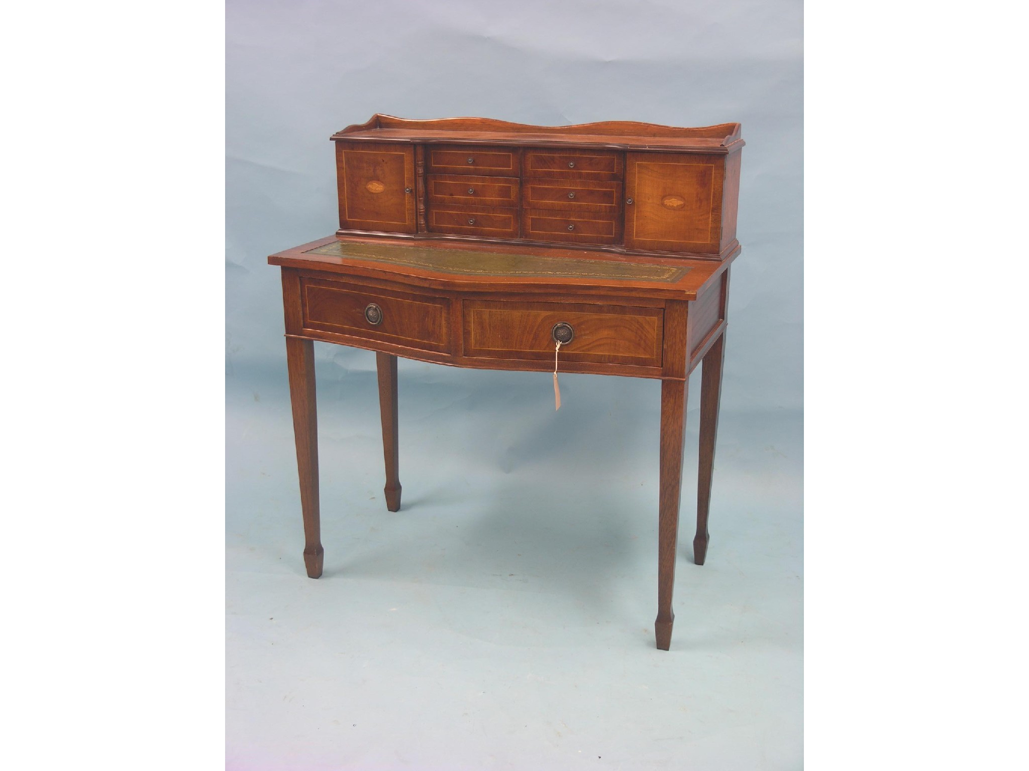 Appraisal: A reproduction mahogany Bonheur du Jour fitted with six short