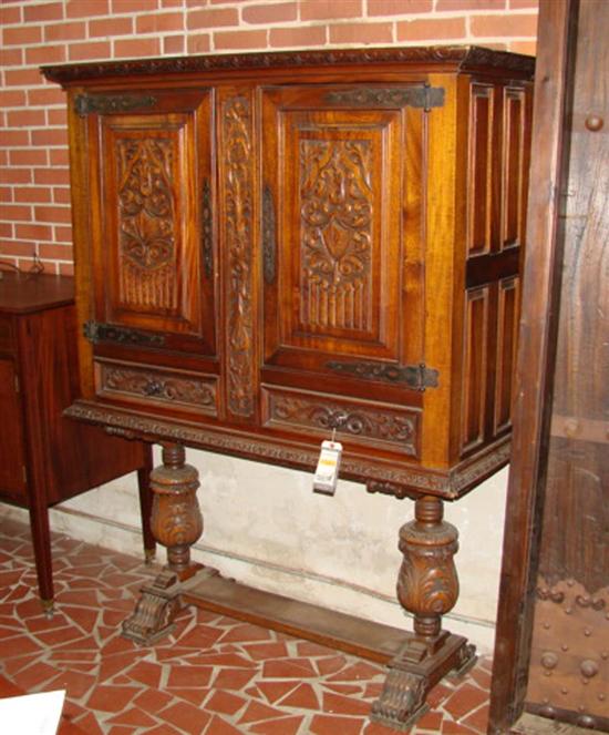 Appraisal: Jacobean style carved mixed hardwood cabinet on stand early th