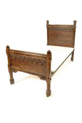 Appraisal: A Victorian carved mahogany 'Gothic' style single bed with an